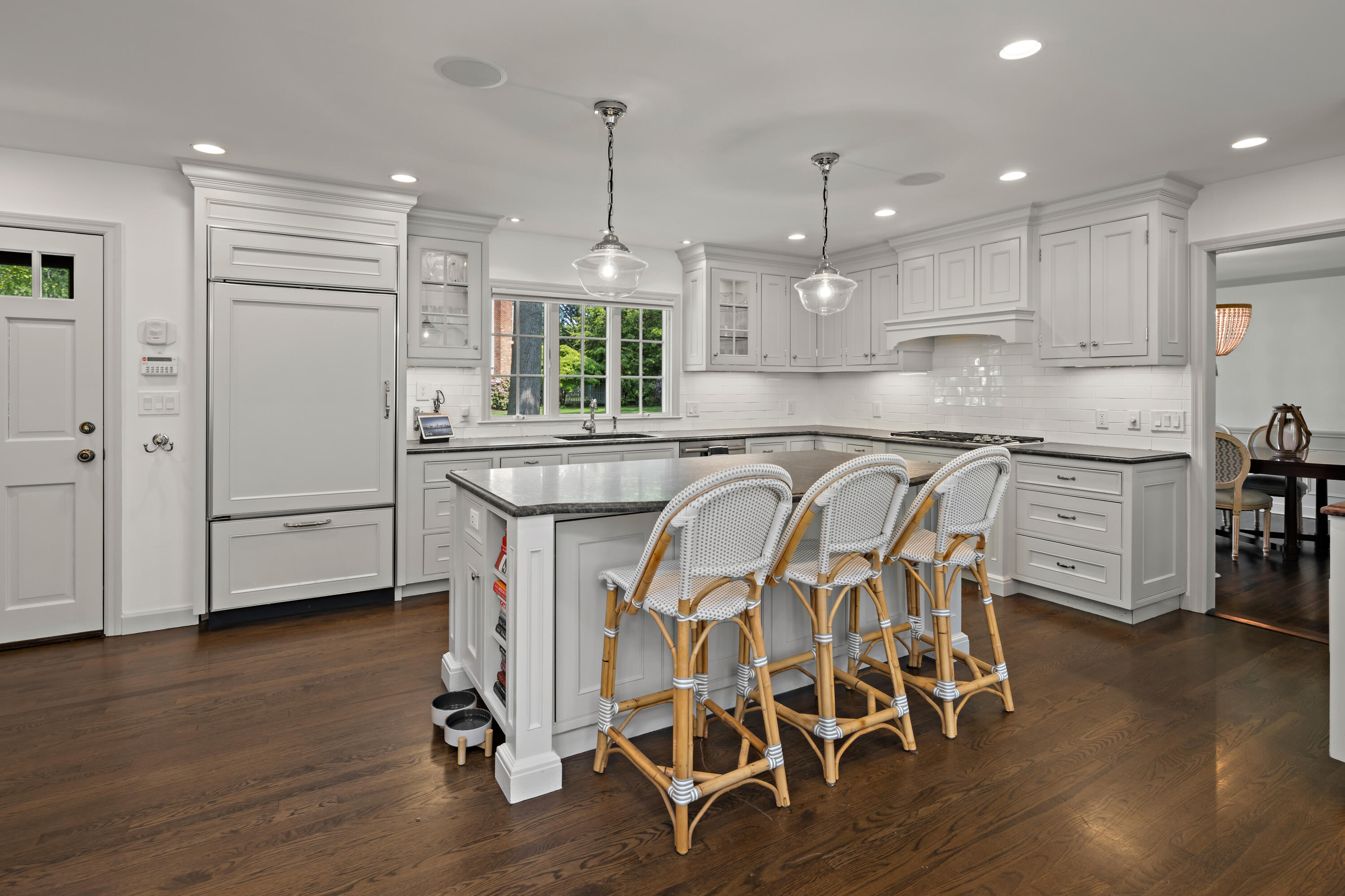 11 Lighthouse Way Darien, CT 06820 - Photo 7 of 25 a kitchen with stainless steel appliances a dining table chairs stove sink and cabinets