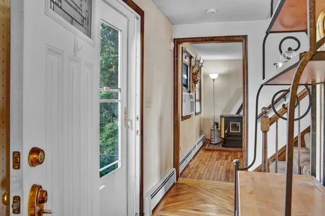 a view of an entryway with wooden floor