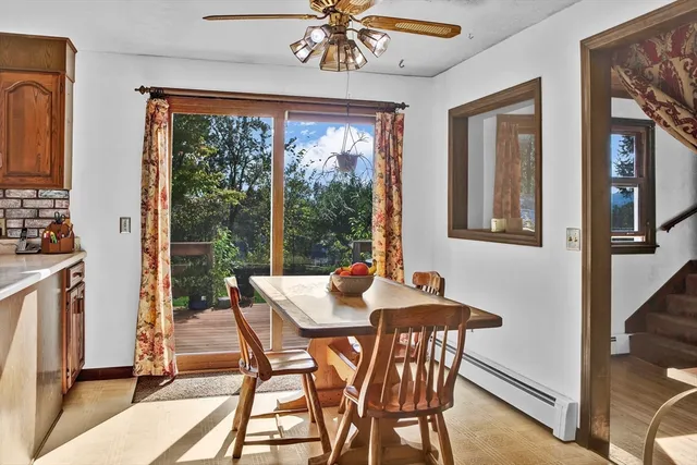 a dining room with furniture a chandelier and wooden floor