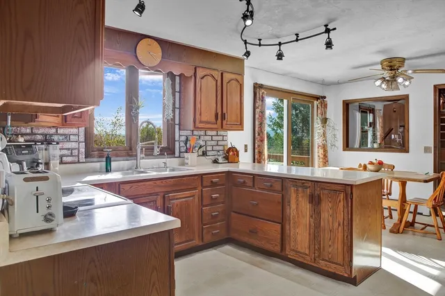 a kitchen with a sink window and cabinets