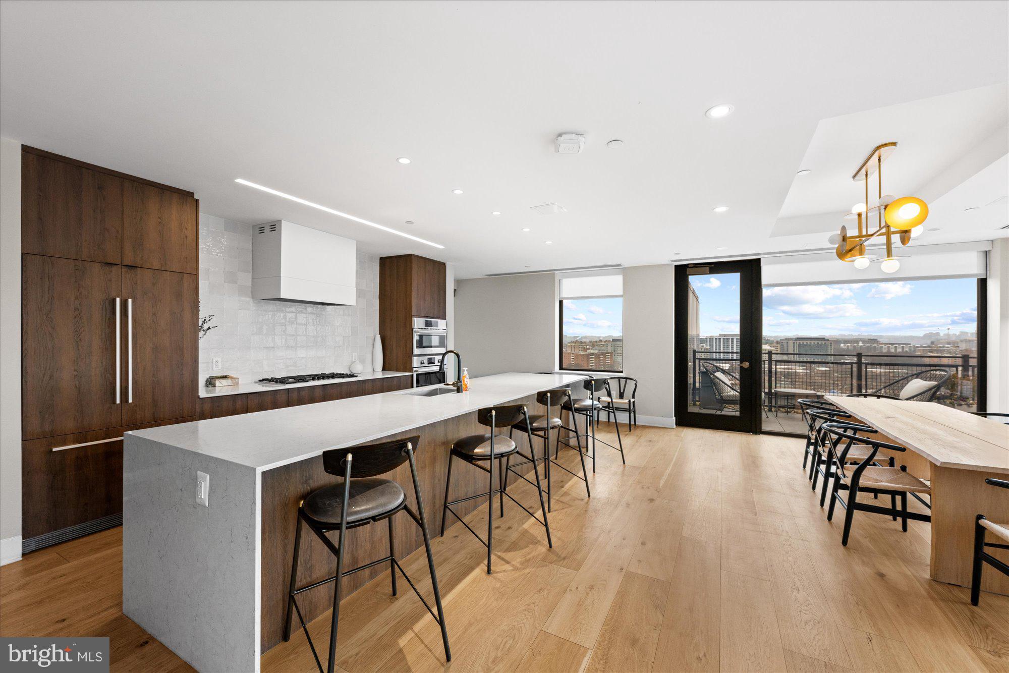 37 L Street Southeast, Unit 1105 Washington, DC 20003 - Photo 13 of 16 a large kitchen with a table and chairs
