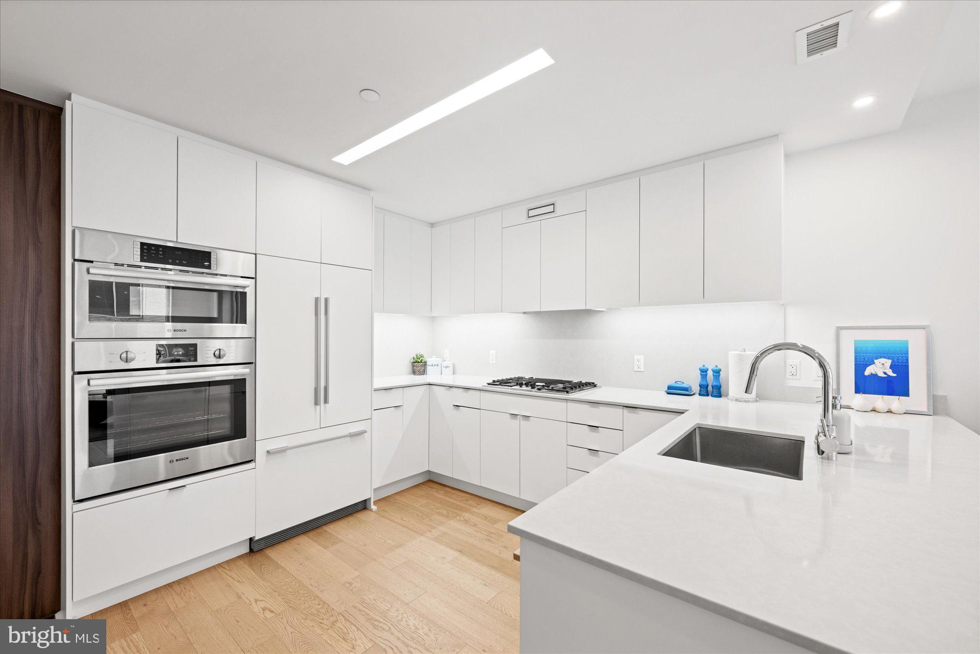 37 L Street Southeast, Unit 1105 Washington, DC 20003 - Photo 7 of 16 a kitchen with granite countertop white cabinets and stainless steel appliances