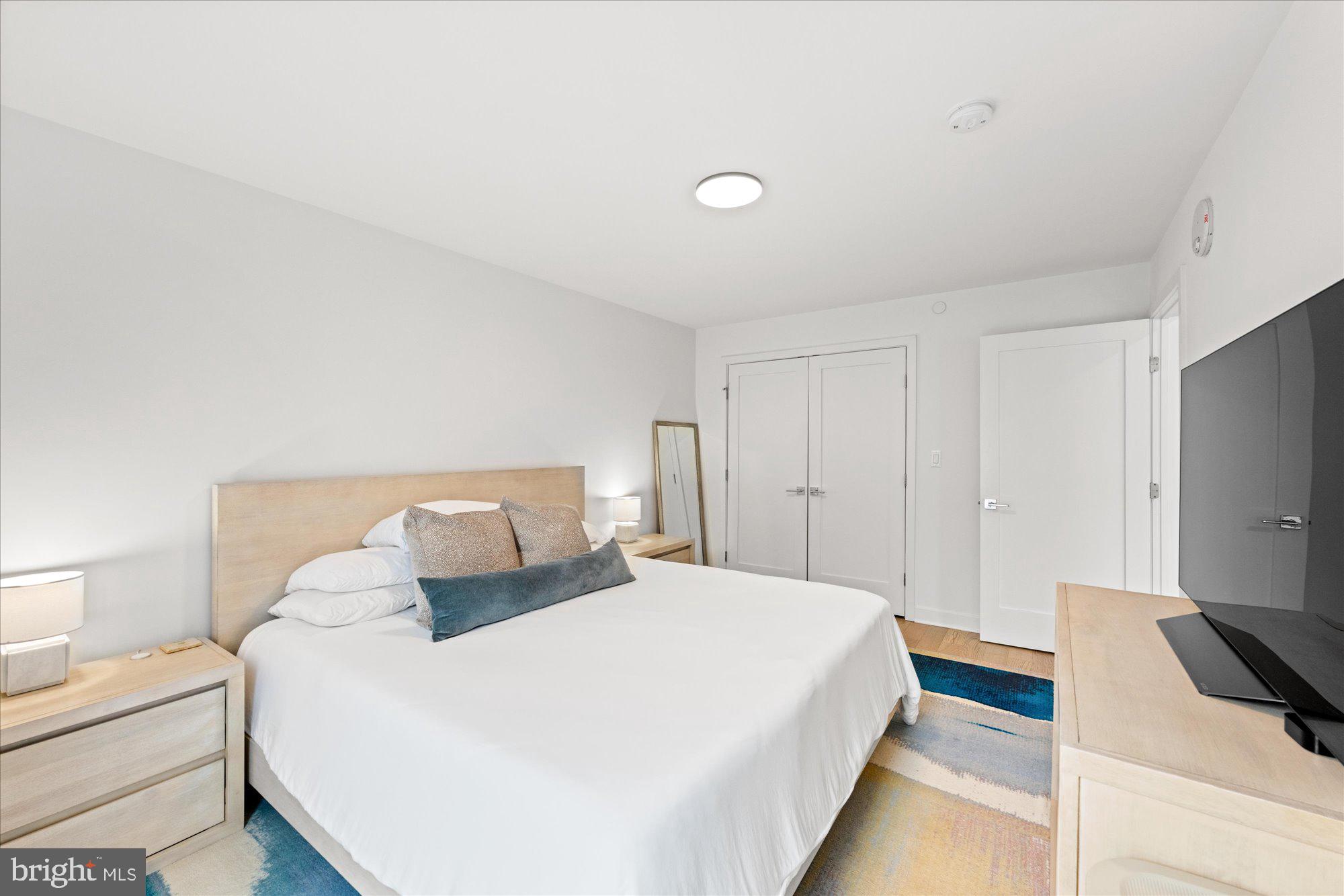 37 L Street Southeast, Unit 1105 Washington, DC 20003 - Photo 10 of 16 a bedroom with a bed and a flat screen tv