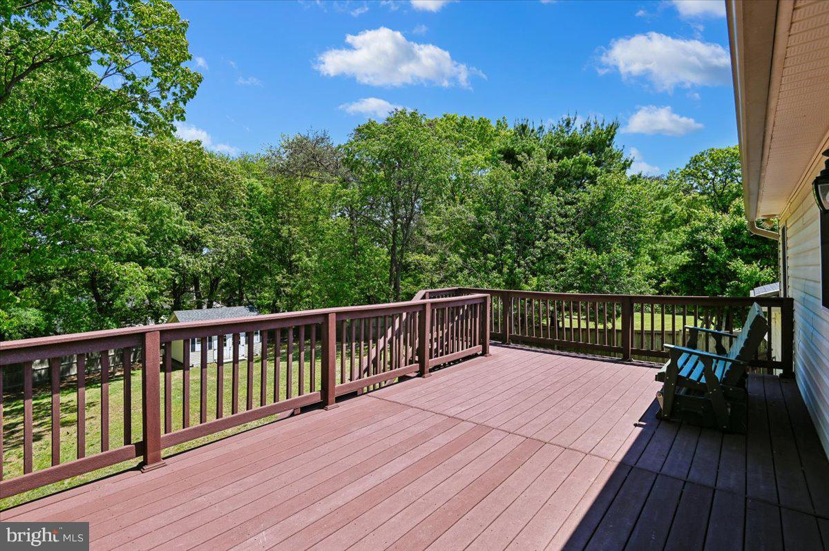 1928 Canonchet Court Hanover, MD 21076 - Photo 11 of 32 a balcony with wooden floor and fence