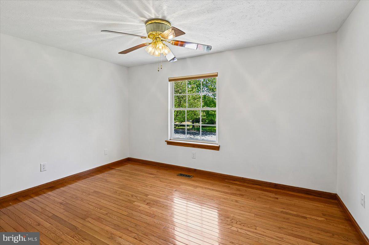1928 Canonchet Court Hanover, MD 21076 - Photo 13 of 32 a view of an empty room with wooden floor and a window