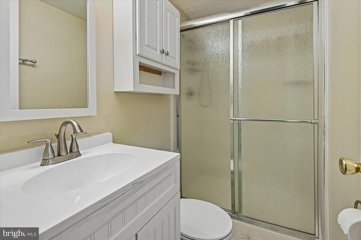 1928 Canonchet Court Hanover, MD 21076 - Photo 24 of 32 a bathroom with a sink a toilet and shower