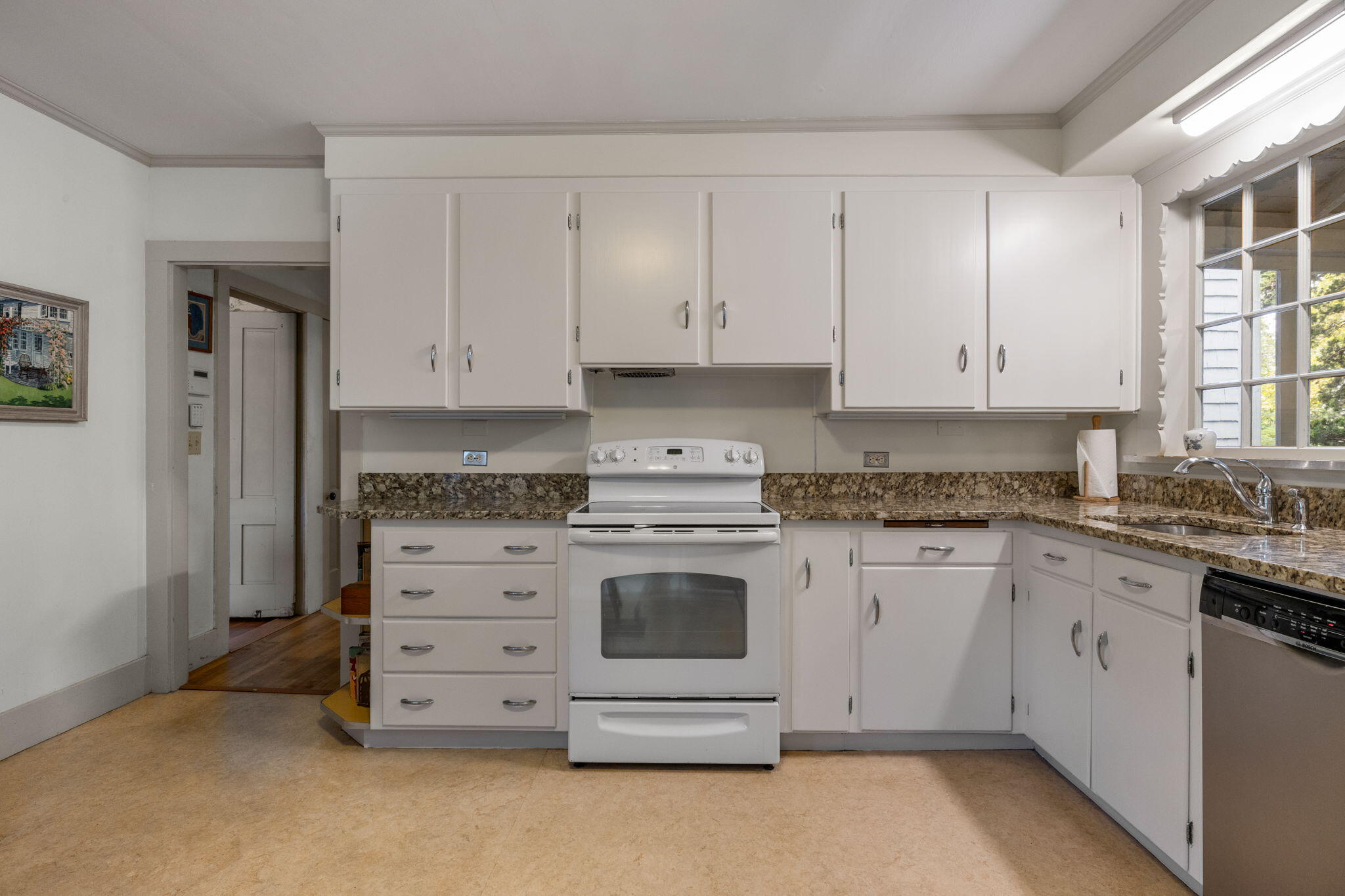 188 Oceanview Avenue Cotuit, MA 02635 - Photo 11 of 76 a kitchen with granite countertop white cabinets and white appliances