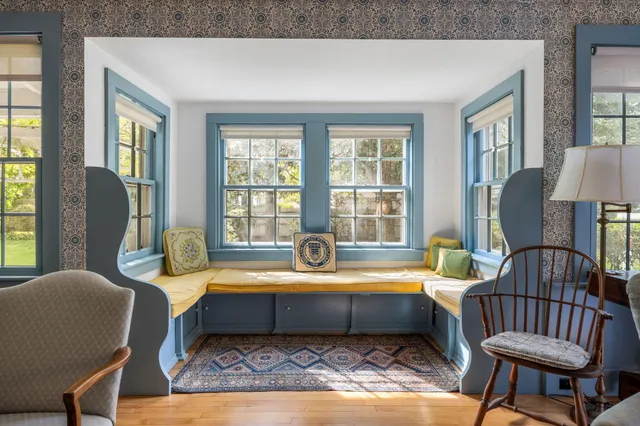 a living room with furniture a fireplace and a bookshelf