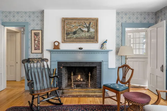 a living room with furniture a rug and a fireplace