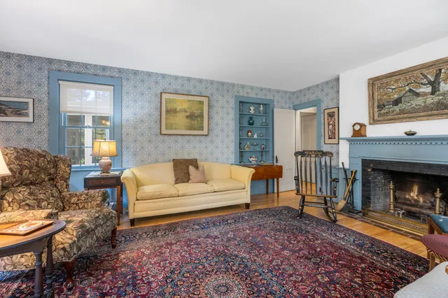 a living room with furniture and a book shelf