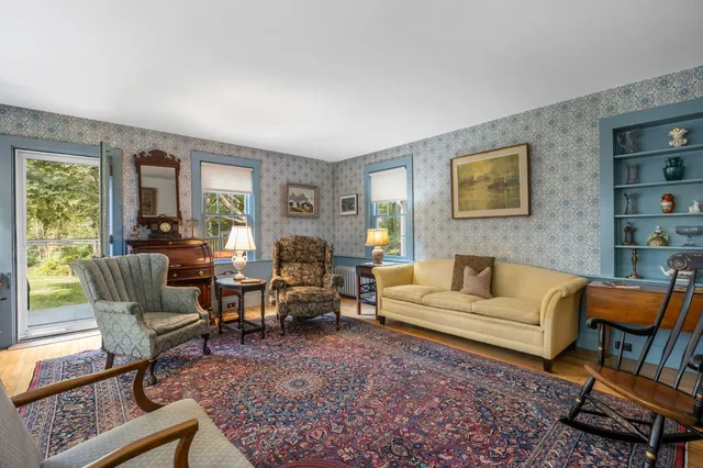 a living room with furniture fireplace and rug