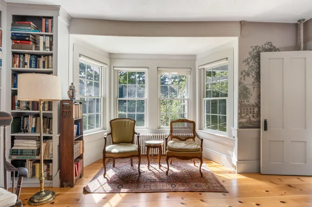 a view of a livingroom with furniture staircase and wooden floor