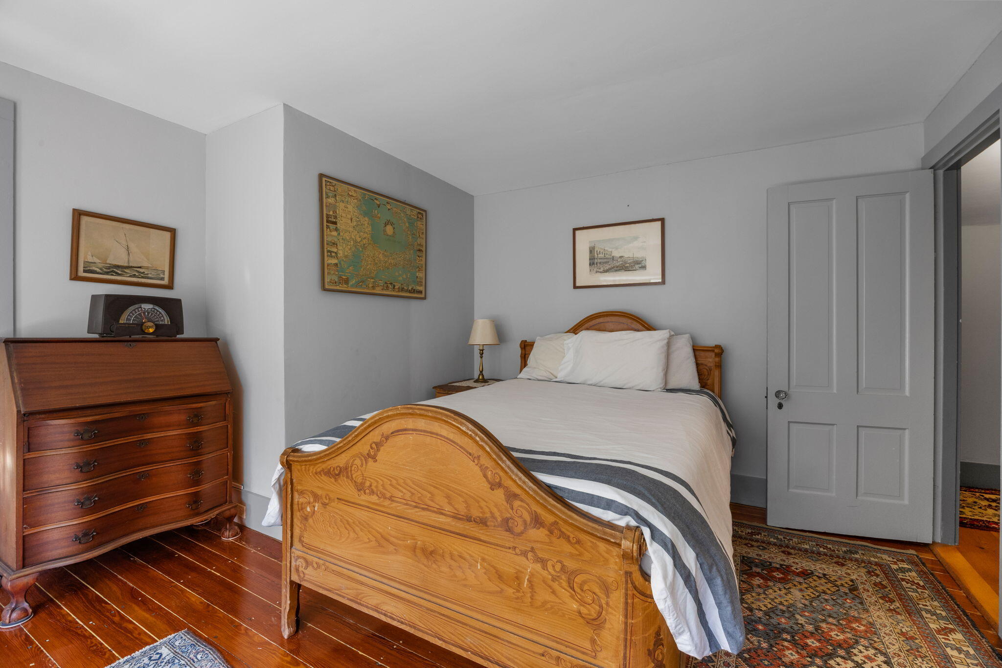 188 Oceanview Avenue Cotuit, MA 02635 - Photo 40 of 76 a bedroom with a bed and wooden floor