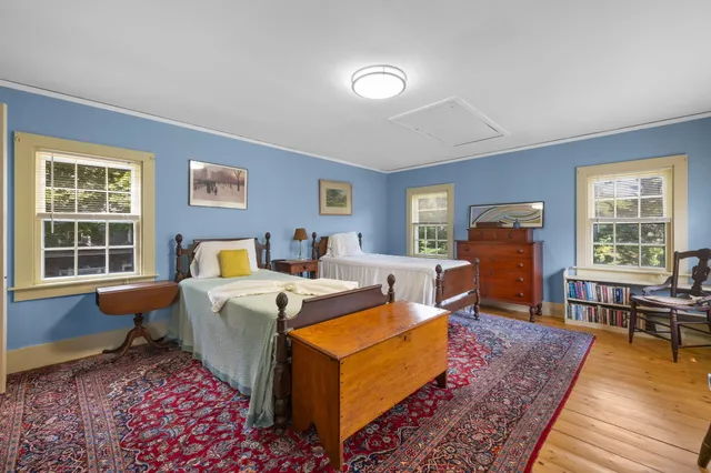 an aerial view of residential houses with outdoor space and trees