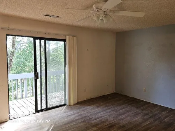 a view of a livingroom with a ceiling fan and window