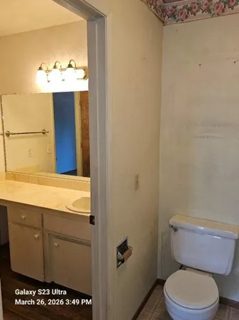 a bathroom with a toilet and a mirror