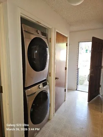 a view of a hallway with washer and dryer