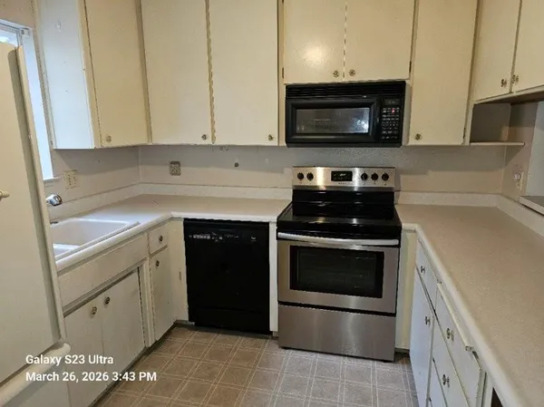 a kitchen with a stove and a microwave