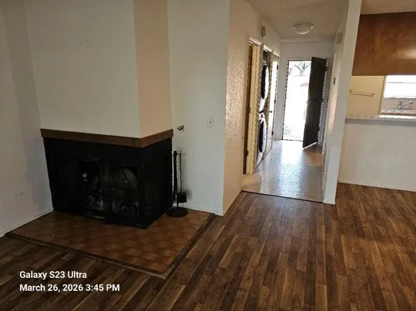 a view of an empty room and wooden floor