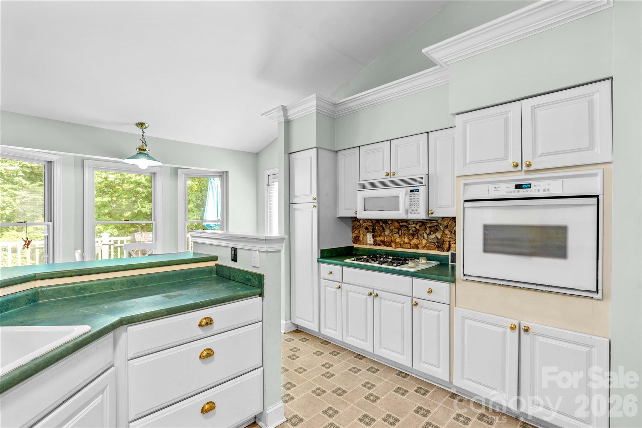 711 Spring Pointe Drive Stony Point, NC 28678 - Photo 17 of 47 a kitchen with granite countertop white cabinets and white appliances