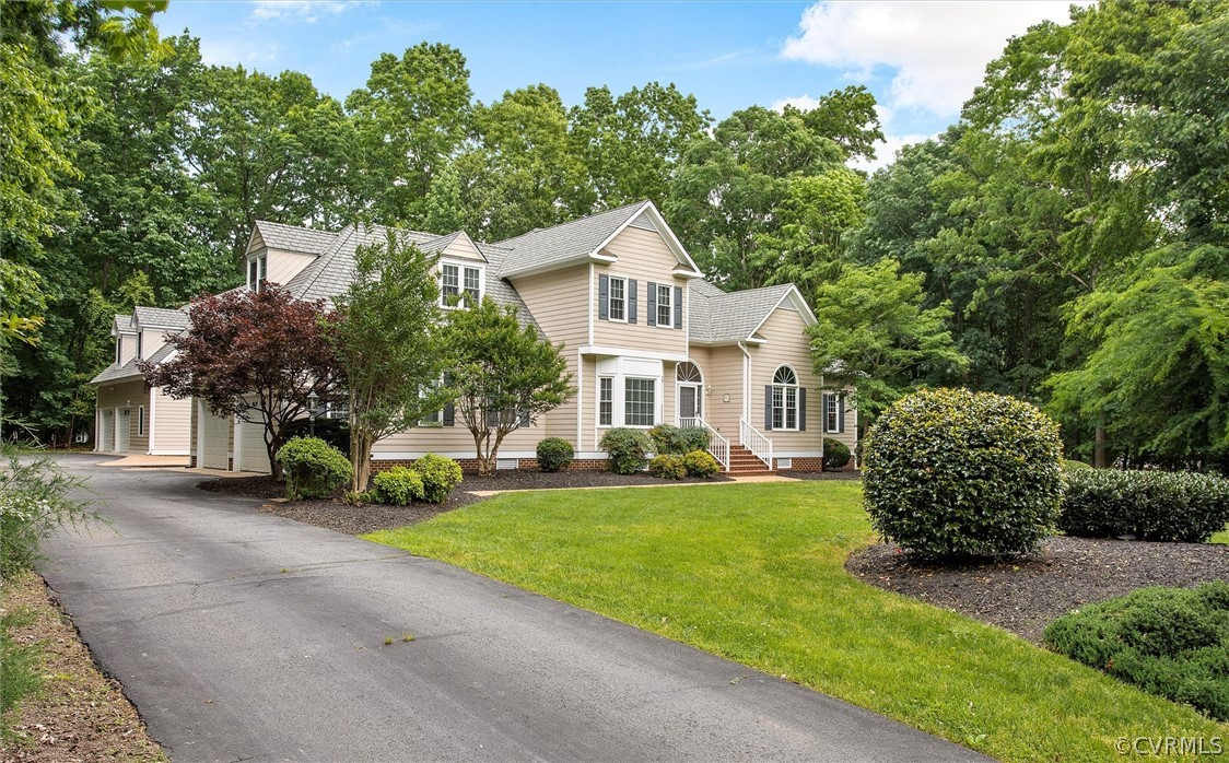 14200 Leafield Drive Midlothian, VA 23113 - Photo 3 of 48 a front view of a house with a garden and trees