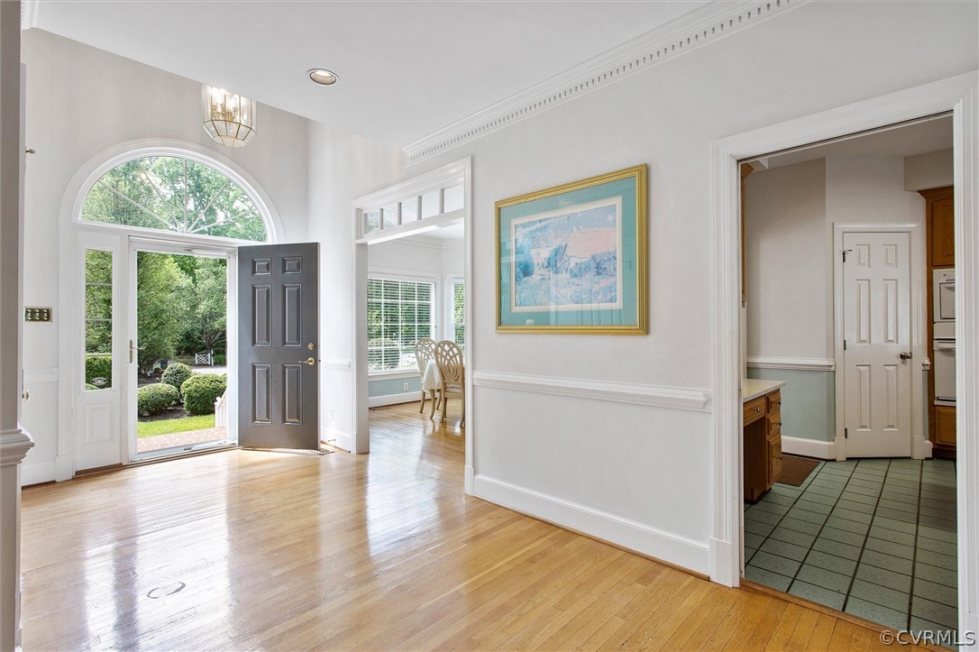 14200 Leafield Drive Midlothian, VA 23113 - Photo 5 of 48 a view of an entryway with wooden floor and a bookshelf
