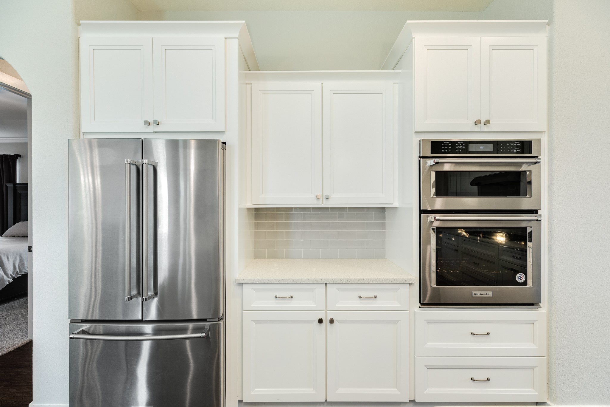527 Lakeland Circle Rosharon, TX 77583 - Photo 24 of 42 a kitchen with white cabinets and stainless steel appliances