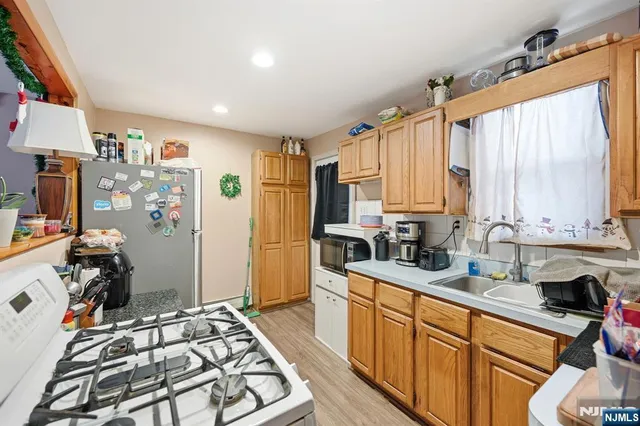 a kitchen with stainless steel appliances a stove a sink and a refrigerator