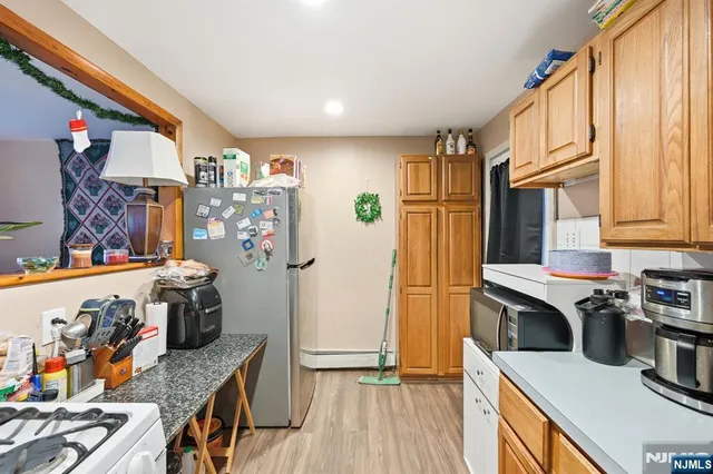 a kitchen with stainless steel appliances granite countertop a refrigerator and a stove top oven