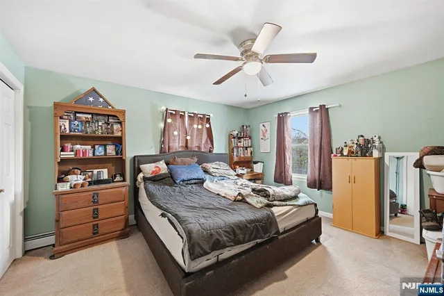a bedroom with a bed furniture and a flat screen tv