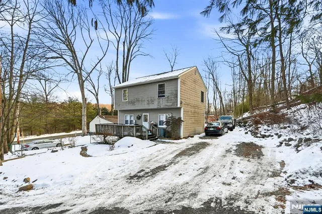 a view of a house with a snow in the yard