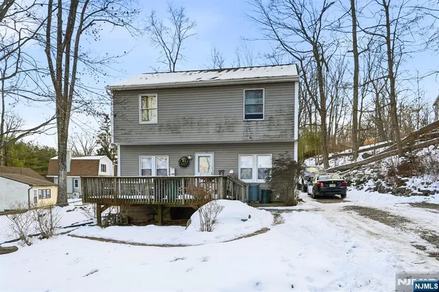 a view of a house with a snow in the yard