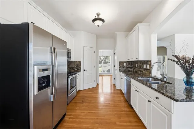 a large kitchen with cabinets and stainless steel appliances