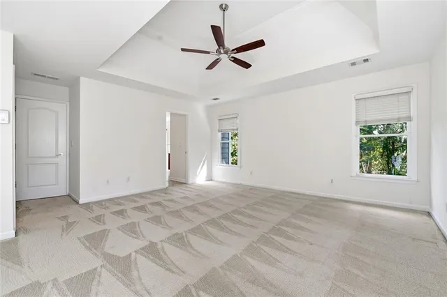 a view of a livingroom with a ceiling fan and window