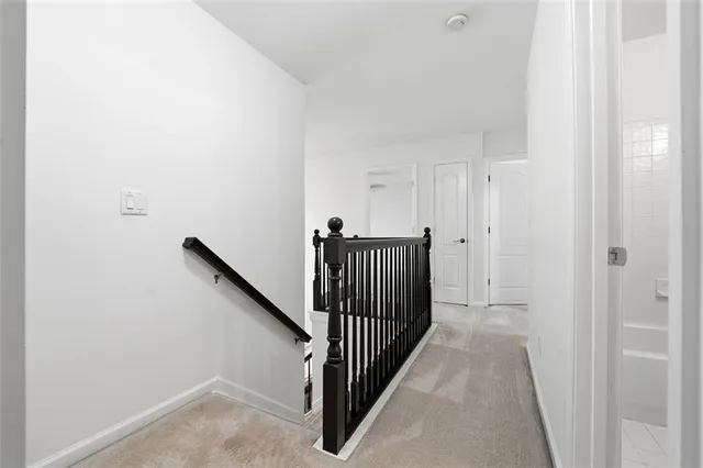 a kitchen with stainless steel appliances granite countertop a sink a microwave stove and white cabinets with wooden floor