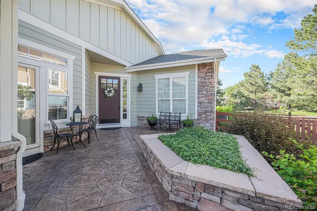 a view of a house with backyard sitting area and garden
