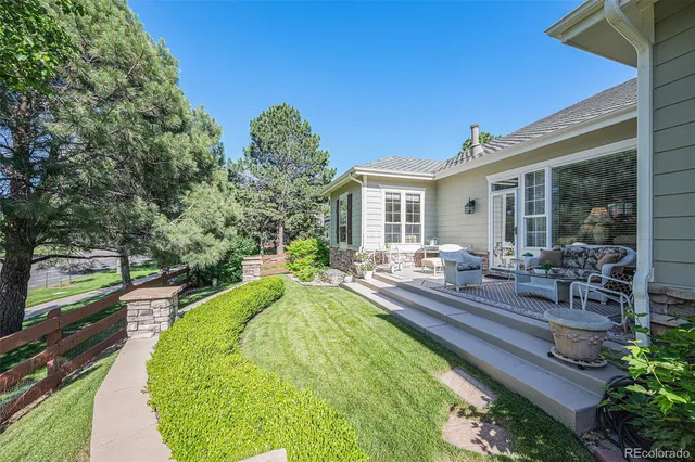 a swimming pool with outdoor seating and yard