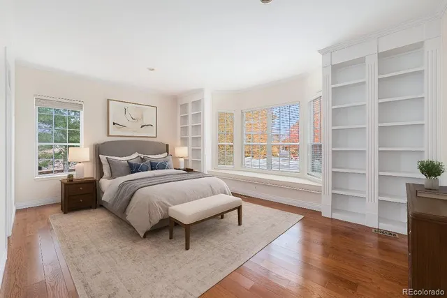 a spacious bedroom with a bed and a large window