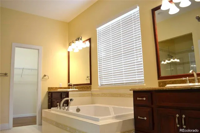a bathroom with a bathtub and a window