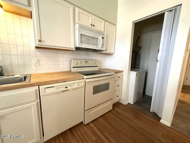 a view of washer and dryer with wooden floor