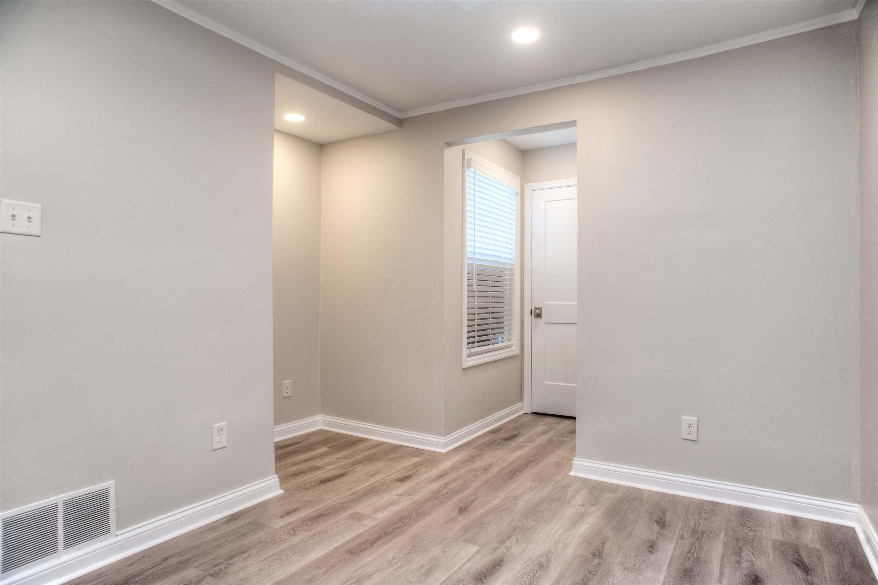 3795 Gamewell Road Memphis, TN 38111 - Photo 14 of 20 a view of an empty room with wooden floor and a window