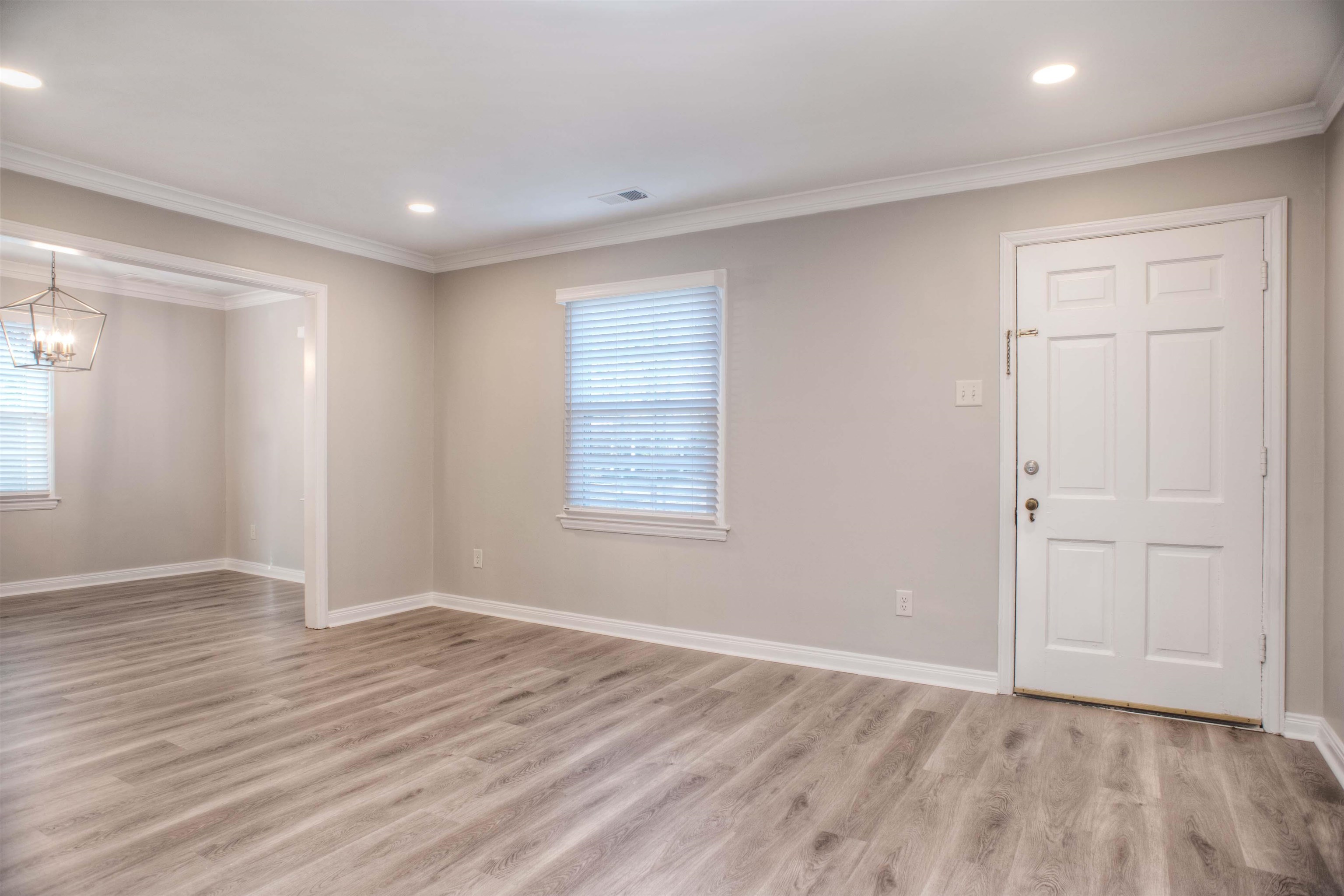 3795 Gamewell Road Memphis, TN 38111 - Photo 3 of 20 a view of an empty room with wooden floor and a window