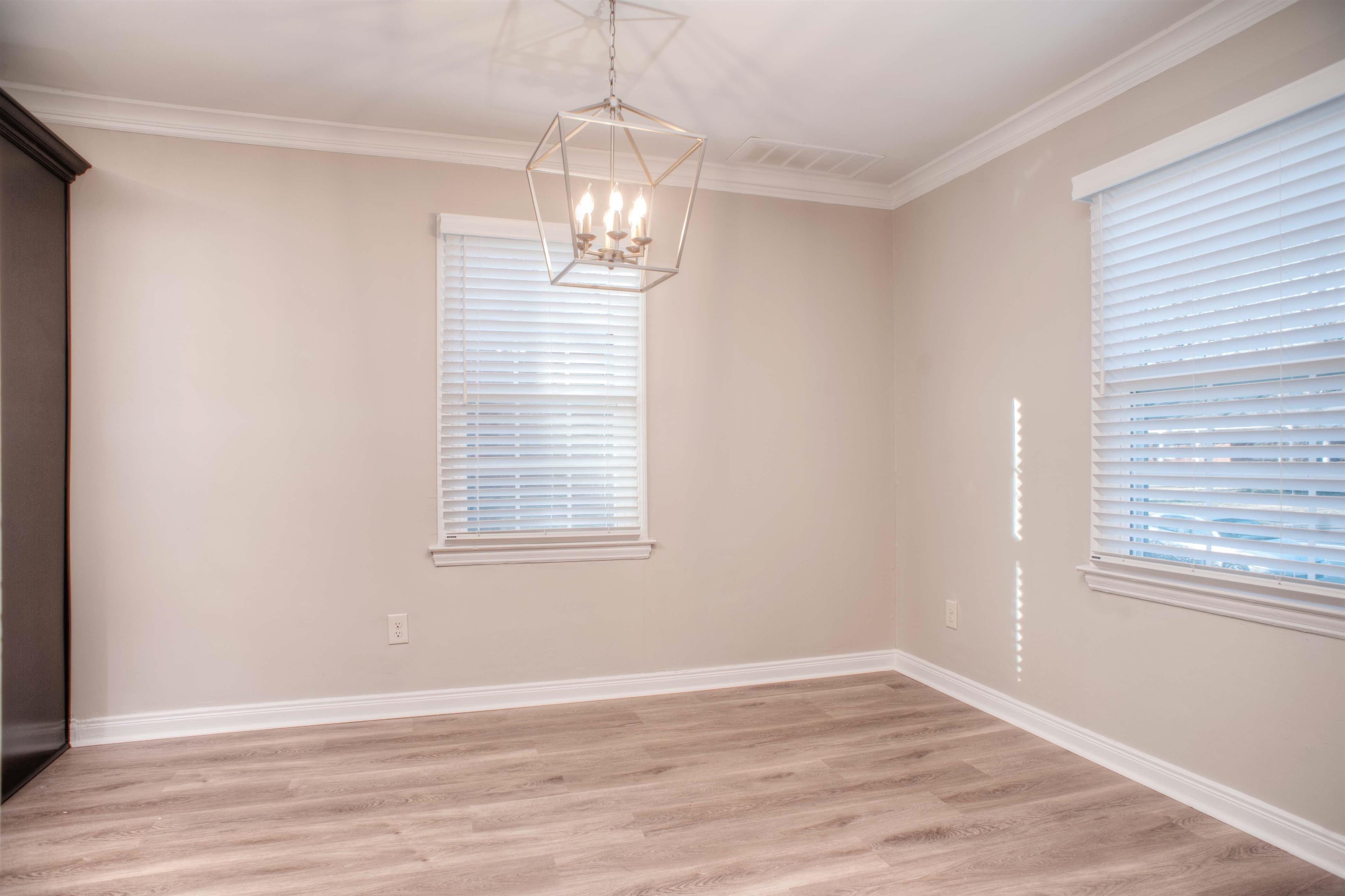 3795 Gamewell Road Memphis, TN 38111 - Photo 4 of 20 an empty room with wooden floor chandelier and window