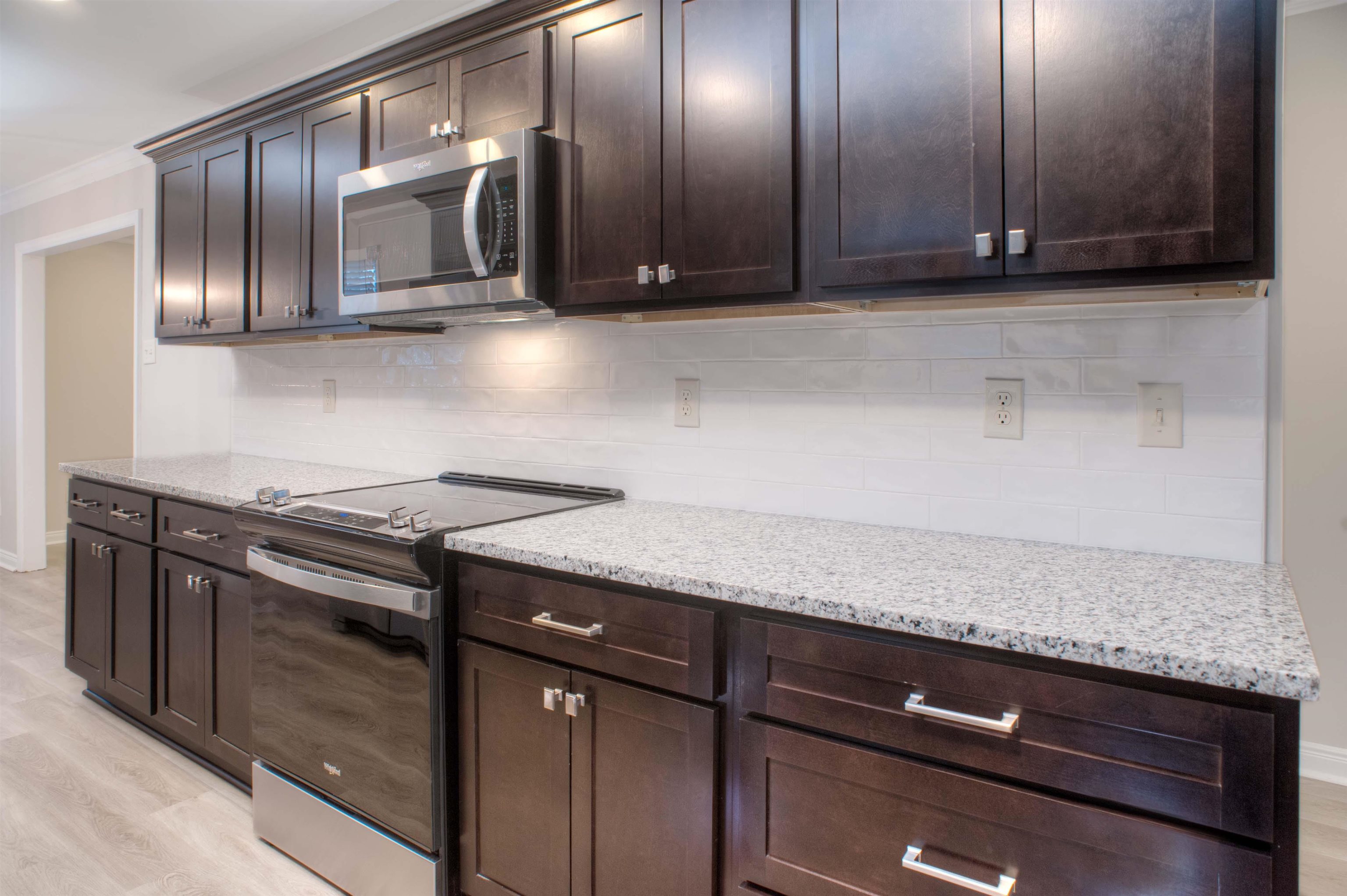 3795 Gamewell Road Memphis, TN 38111 - Photo 6 of 20 a kitchen with granite countertop stainless steel appliances a stove microwave and cabinets