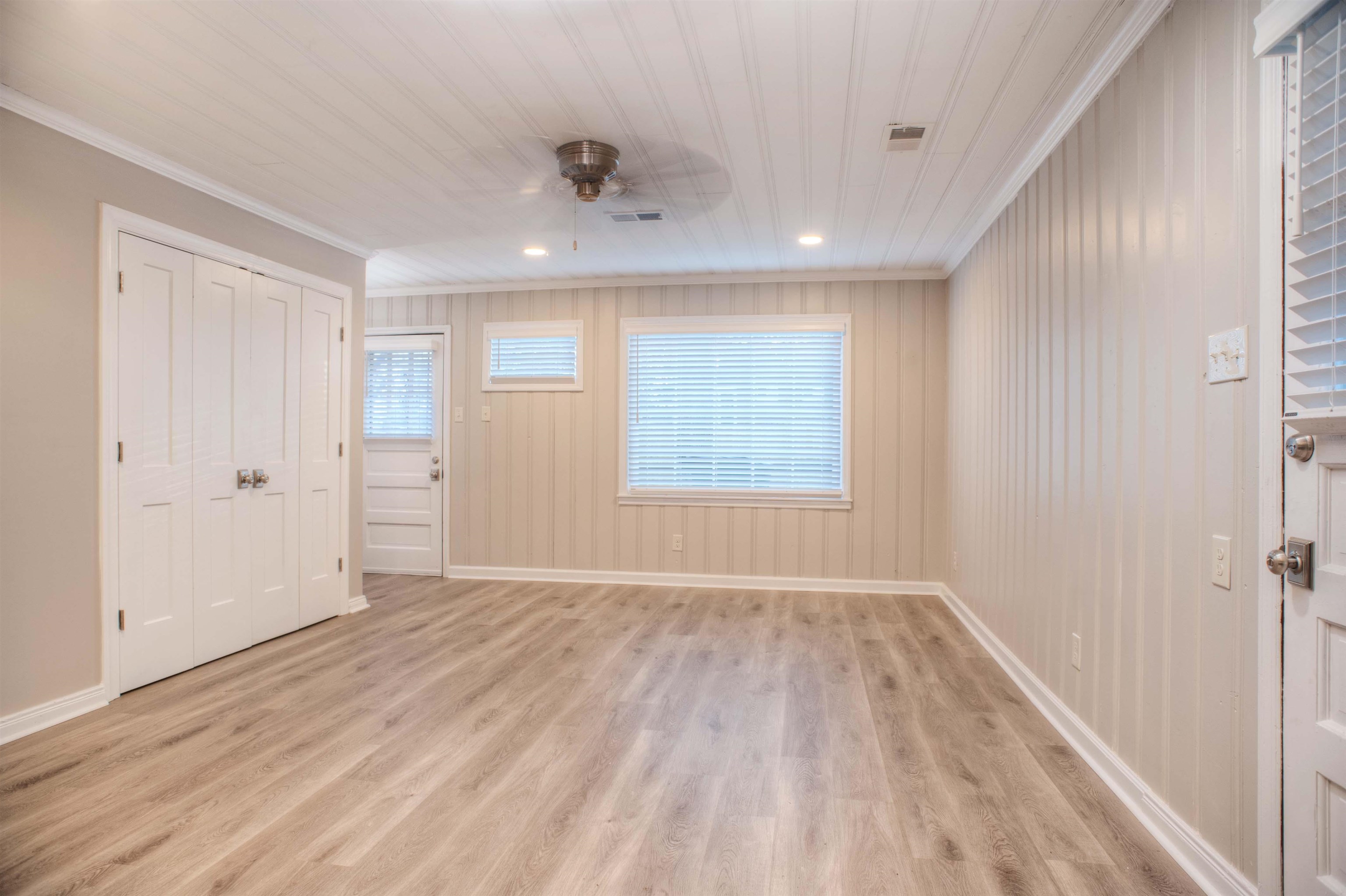 3795 Gamewell Road Memphis, TN 38111 - Photo 8 of 20 an empty room with wooden floor and windows