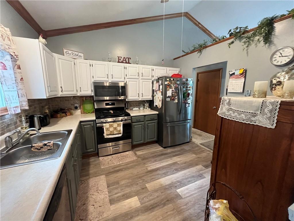 101 Dolphin Drive Butler, PA 16002 - Photo 12 of 27 a kitchen with stainless steel appliances granite countertop a refrigerator a stove and a sink with wooden floor