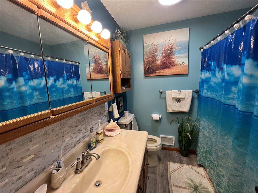 101 Dolphin Drive Butler, PA 16002 - Photo 14 of 27 a bathroom with a sink and mirror with bathtub