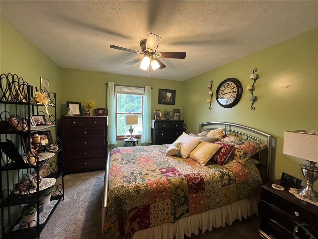 101 Dolphin Drive Butler, PA 16002 - Photo 15 of 27 a bedroom with a bed and a table in it