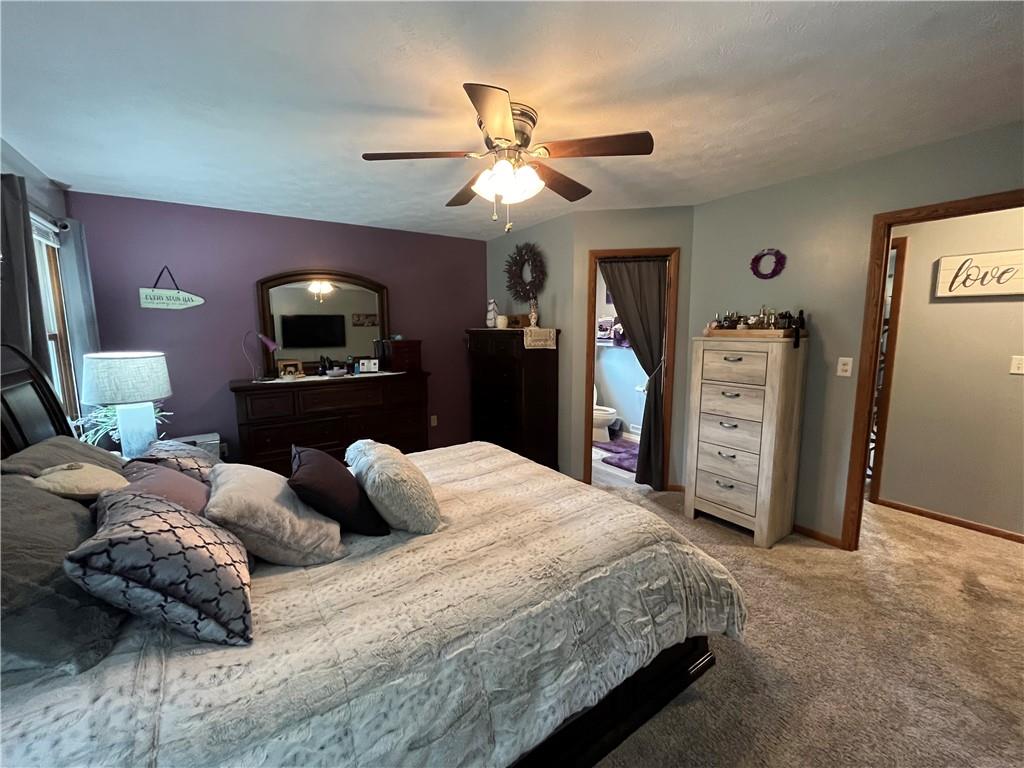 101 Dolphin Drive Butler, PA 16002 - Photo 16 of 27 a bedroom with bed and a chandelier