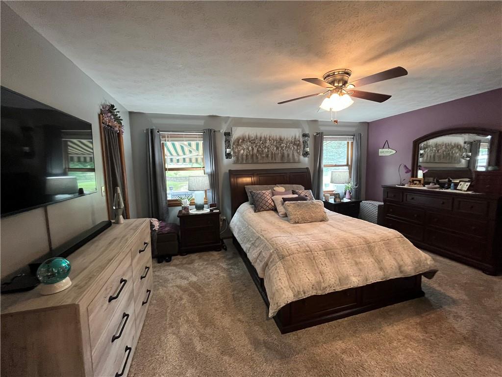 101 Dolphin Drive Butler, PA 16002 - Photo 17 of 27 a bedroom with a large bed and a chandelier